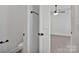 A view of the toilet, towel rack and doorway to the bedroom at 6154 Lowder Rd, Salisbury, NC 28147