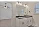 This bathroom boasts double sinks with black fixtures and a large mirror over white cabinetry at 6154 Lowder Rd, Salisbury, NC 28147