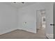 This bedroom features light wood-look floors and access to an ensuite bath and hallway at 6154 Lowder Rd, Salisbury, NC 28147