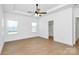 Spacious bedroom featuring wood-look floors, ceiling fan, and plenty of natural light at 6154 Lowder Rd, Salisbury, NC 28147