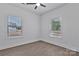 This bedroom features light wood-look floors and bright natural light from two windows at 6154 Lowder Rd, Salisbury, NC 28147