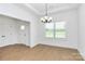 Inviting dining room with natural light and wood-look floors, complemented by an elegant chandelier at 6154 Lowder Rd, Salisbury, NC 28147