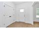 Bright entryway with wood-look flooring, closet for storage, and door with window at 6154 Lowder Rd, Salisbury, NC 28147