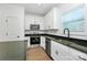 Bright kitchen with stainless steel appliances, modern white cabinetry and dark granite countertops at 6154 Lowder Rd, Salisbury, NC 28147