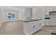 Bright kitchen boasts white cabinets, a central island and stainless steel microwave appliance at 6154 Lowder Rd, Salisbury, NC 28147