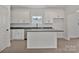 Well-lit kitchen boasts an island, dishwasher, and plentiful counter space and cabinets at 6154 Lowder Rd, Salisbury, NC 28147