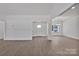 Bright, open-concept living space with modern flooring, large windows, and a stylish chandelier at 6154 Lowder Rd, Salisbury, NC 28147