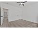 Neutral bedroom with closet space, ceiling fan, and wood-look flooring at 6160 Lowder Rd, Salisbury, NC 28147