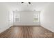 Bright bedroom with hardwood floors, natural light from two windows, and a closet door at 6160 Lowder Rd, Salisbury, NC 28147