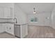Open concept kitchen includes granite countertops, white cabinets, and a stainless steel dishwasher at 6160 Lowder Rd, Salisbury, NC 28147