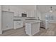 Well-lit kitchen featuring granite countertops, white cabinets, stainless steel dishwasher, and microwave at 6160 Lowder Rd, Salisbury, NC 28147