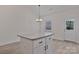 Kitchen island with granite countertop, white cabinets, and overhead lighting at 6160 Lowder Rd, Salisbury, NC 28147
