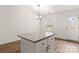 Bright kitchen featuring a granite island, white cabinets, and stainless steel appliances at 6160 Lowder Rd, Salisbury, NC 28147