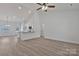 Spacious living area with open layout, light wood floors, and view of the kitchen with breakfast bar at 6160 Lowder Rd, Salisbury, NC 28147