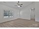 Bright living room with neutral walls, light wood floors, large window, and ceiling fan at 6160 Lowder Rd, Salisbury, NC 28147