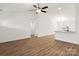 Open-concept living room with a view of the kitchen, featuring hardwood floors and bright lighting at 6160 Lowder Rd, Salisbury, NC 28147