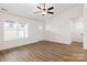 Bright living room featuring hardwood floors, ceiling fan, and a large window for natural light at 6160 Lowder Rd, Salisbury, NC 28147