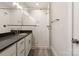 Well-lit bathroom with modern vanity and a glass-enclosed shower with tiled walls and flooring at 320 Ferebee Pl # Brx0021, Charlotte, NC 28213