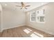 Light-filled bedroom with modern vinyl floors, neutral walls, and a ceiling fan, creating a clean and stylish ambiance at 320 Ferebee Pl # Brx0021, Charlotte, NC 28213
