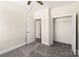 Bright bedroom with neutral walls, plush carpet, closet, and an open door that offers versatile usage at 320 Ferebee Pl # Brx0021, Charlotte, NC 28213