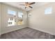 Bright bedroom with carpet, ceiling fan, and windows providing natural light at 320 Ferebee Pl # Brx0021, Charlotte, NC 28213