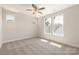 Bright bedroom with carpet, ceiling fan, and multiple windows providing natural light at 320 Ferebee Pl # Brx0021, Charlotte, NC 28213