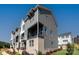 Contemporary townhome with a brick base, gray siding, and a private balcony, offering stylish curb appeal at 320 Ferebee Pl # Brx0021, Charlotte, NC 28213