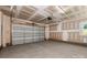 Spacious two-car garage with an automatic door and unfinished walls, ideal for secure parking and storage at 320 Ferebee Pl # Brx0021, Charlotte, NC 28213