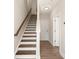 Hallway and staircase with wood and white painted risers, and luxury vinyl plank flooring at 320 Ferebee Pl # Brx0021, Charlotte, NC 28213