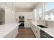 Kitchen boasts white cabinetry, quartz countertops, stainless steel appliances, and laminate floors at 320 Ferebee Pl # Brx0021, Charlotte, NC 28213