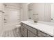 Bathroom featuring a bath and shower, white cabinets, grey vanity and patterned floor at 312 Ferebee Pl # Brx0023, Charlotte, NC 28213