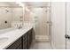 Bright bathroom featuring dual sinks, a sleek vanity, and a glass-enclosed shower at 312 Ferebee Pl # Brx0023, Charlotte, NC 28213