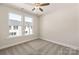 Bright bedroom featuring neutral walls, carpet, two large windows and ceiling fan at 312 Ferebee Pl # Brx0023, Charlotte, NC 28213