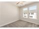 Neutral bedroom featuring two large windows, ceiling fan and light gray carpet at 312 Ferebee Pl # Brx0023, Charlotte, NC 28213
