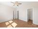 Bedroom with hardwood floors, ceiling fan, two doors and open closet at 312 Ferebee Pl # Brx0023, Charlotte, NC 28213