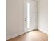 Bright entryway with white door with glass insert, light wood floors, and neutral walls at 312 Ferebee Pl # Brx0023, Charlotte, NC 28213