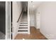 Bright entryway with hardwood floors, a staircase, and white walls leading into the home at 312 Ferebee Pl # Brx0023, Charlotte, NC 28213