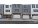 View of the townhome garages, showcasing the multiple attached garages with white doors at 312 Ferebee Pl # Brx0023, Charlotte, NC 28213