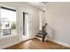 Bright hallway with wood floors, a staircase, and a door leading to a balcony or outdoor area at 312 Ferebee Pl # Brx0023, Charlotte, NC 28213