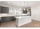 Modern kitchen featuring gray cabinets, white countertops, stainless steel appliances, and pendant lighting at 312 Ferebee Pl # Brx0023, Charlotte, NC 28213