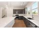 Modern kitchen with sleek gray cabinetry, a large island, and stainless steel appliances at 312 Ferebee Pl # Brx0023, Charlotte, NC 28213