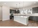 Bright modern kitchen with gray cabinets, white countertops, and a central island at 312 Ferebee Pl # Brx0023, Charlotte, NC 28213