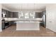 Modern kitchen with gray cabinets, a large white island, and stainless steel appliances at 312 Ferebee Pl # Brx0023, Charlotte, NC 28213