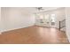 Bright living room features wood floors, a ceiling fan, and access to outdoor balcony or patio at 312 Ferebee Pl # Brx0023, Charlotte, NC 28213