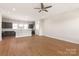 Bright living room with an open-concept layout featuring wood floors, stainless appliances, and recessed lighting at 312 Ferebee Pl # Brx0023, Charlotte, NC 28213
