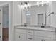 Bathroom featuring double sinks, granite countertop, white cabinets, and brushed nickel fixtures at 6133 Long Branch Rd, Salisbury, NC 28147