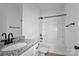 Bathroom with shower-tub combo, granite countertop vanity, and black hardware at 6133 Long Branch Rd, Salisbury, NC 28147