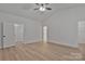 Bedroom featuring light wood-look floors, a ceiling fan, and interior door at 6133 Long Branch Rd, Salisbury, NC 28147