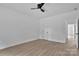 Bedroom featuring light wood-look flooring, ceiling fan, and white painted door at 6133 Long Branch Rd, Salisbury, NC 28147