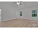 Bedroom with light wood-look flooring, a ceiling fan, and bright double windows at 6133 Long Branch Rd, Salisbury, NC 28147